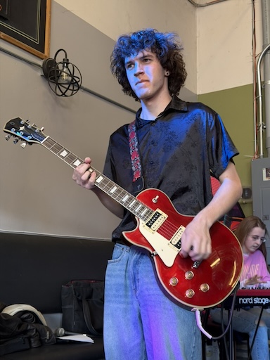 Garrett Holding a red guitar